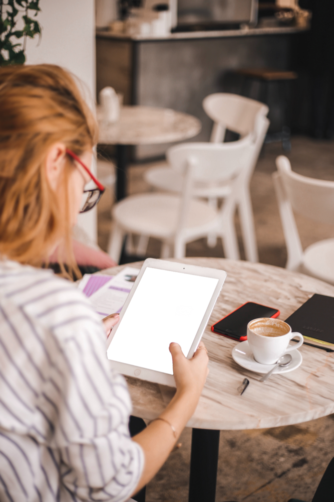 Tablet Mockup: girl holding tablet in the coffee shop